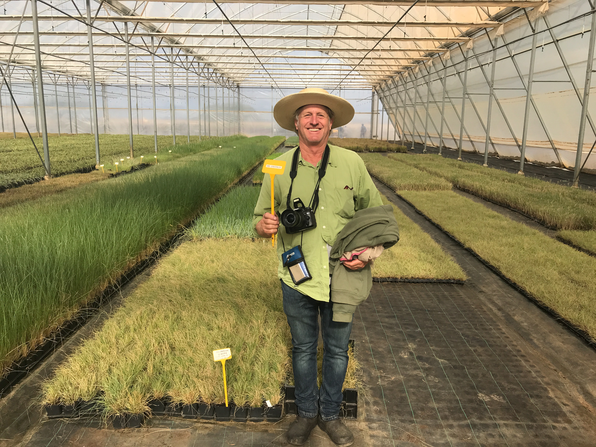 John Greenlee standing in front of a nursery contract grow order.