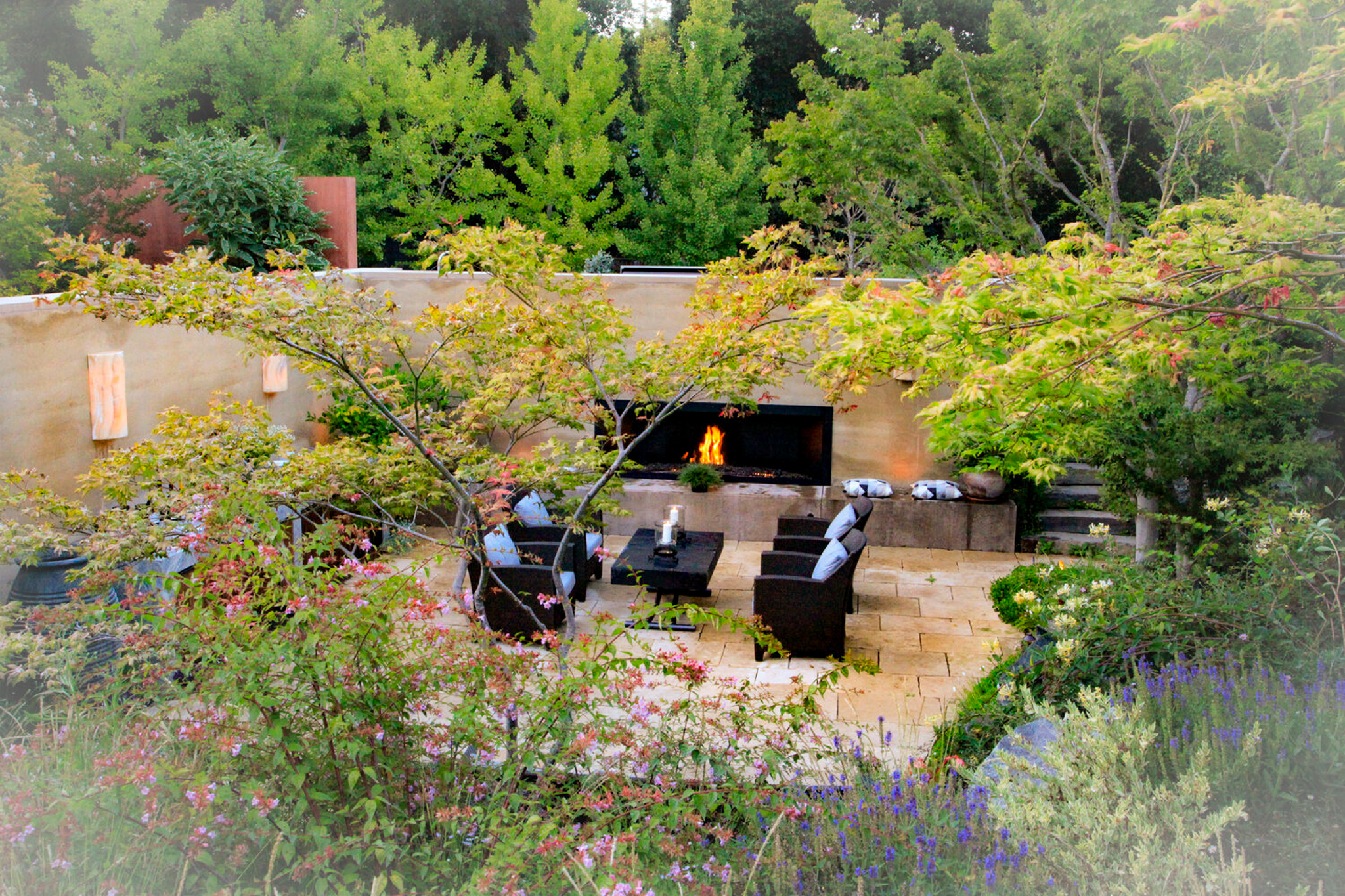 Fog surrounds the sunken patio and an eclectic mixture of colorful plants.