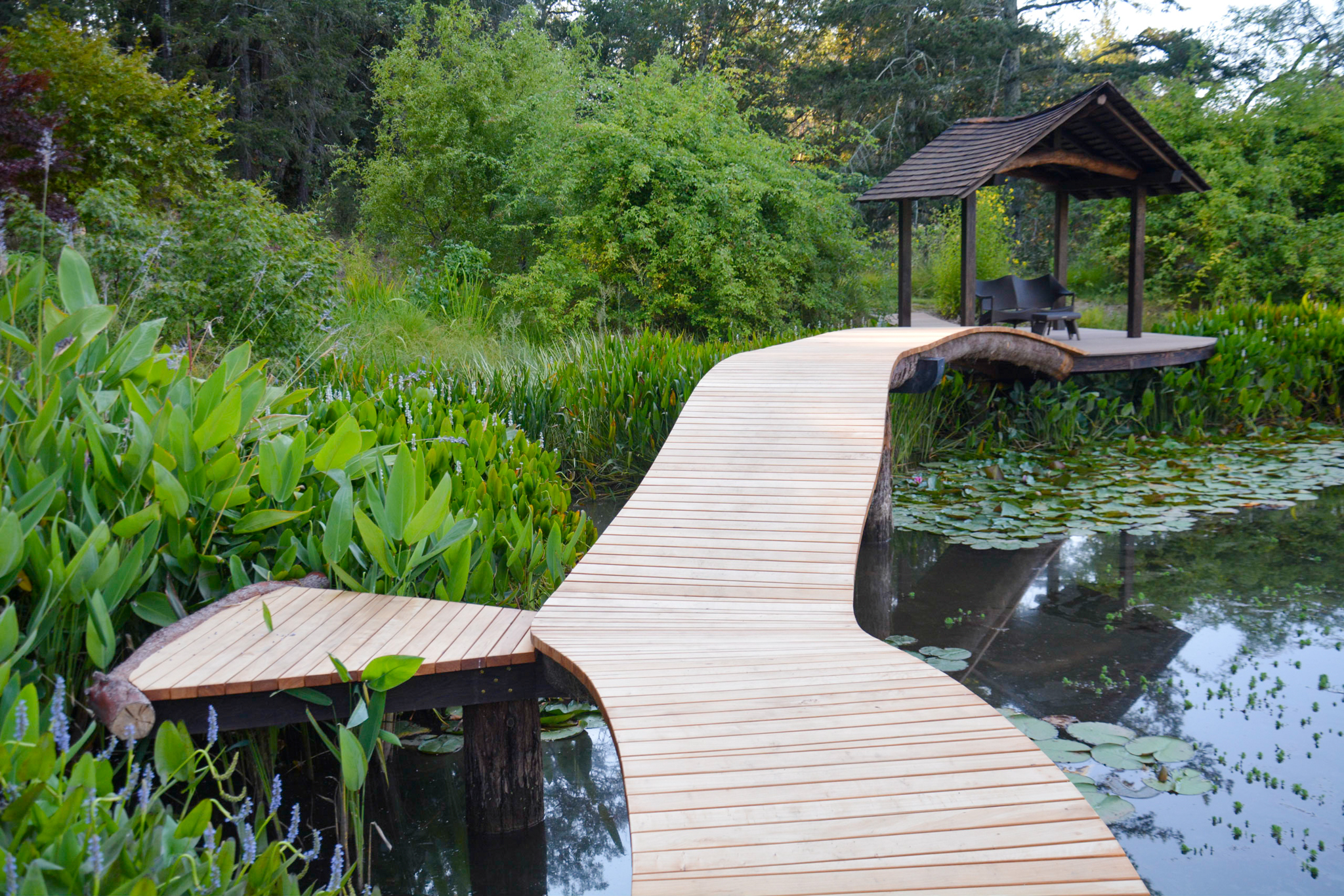 A japanese wooden walkway stands over the water.