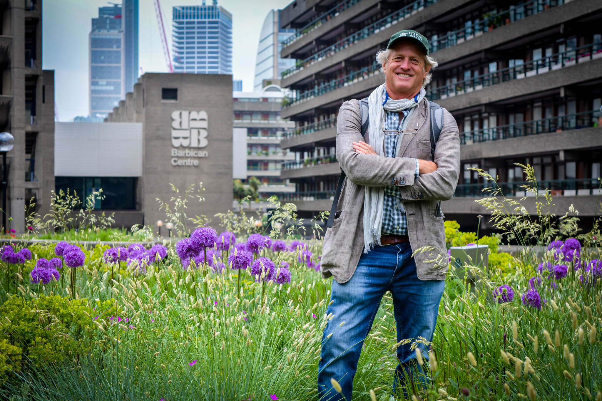 A headshot of John Greenlee standing in a garden.